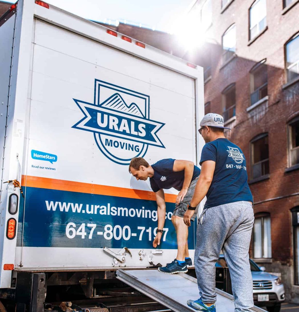 Urals Moving Company team at the back of the truck in uniform