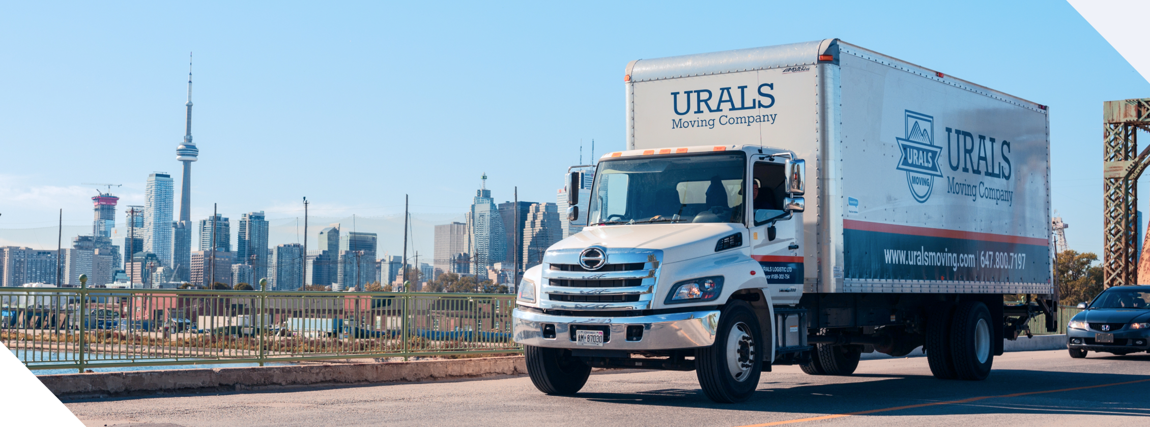Urals Moving Truck on the road in Toronto with CN Tower